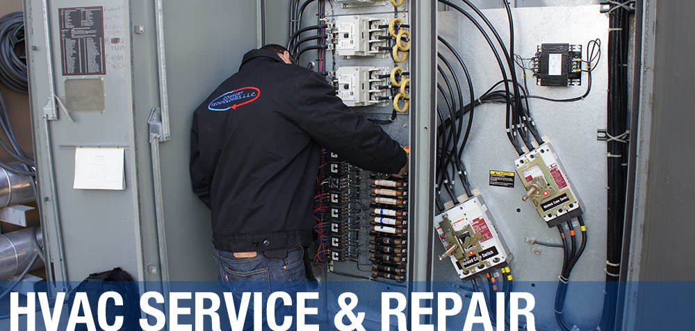 technician repairing and servicing HVAC system